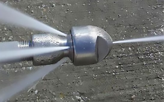 High pressure water jetting nozzle spraying jets of water